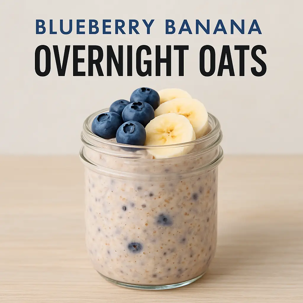 Glass jar filled with blueberry banana overnight oats topped with fresh blueberries and banana slices on a wooden table.