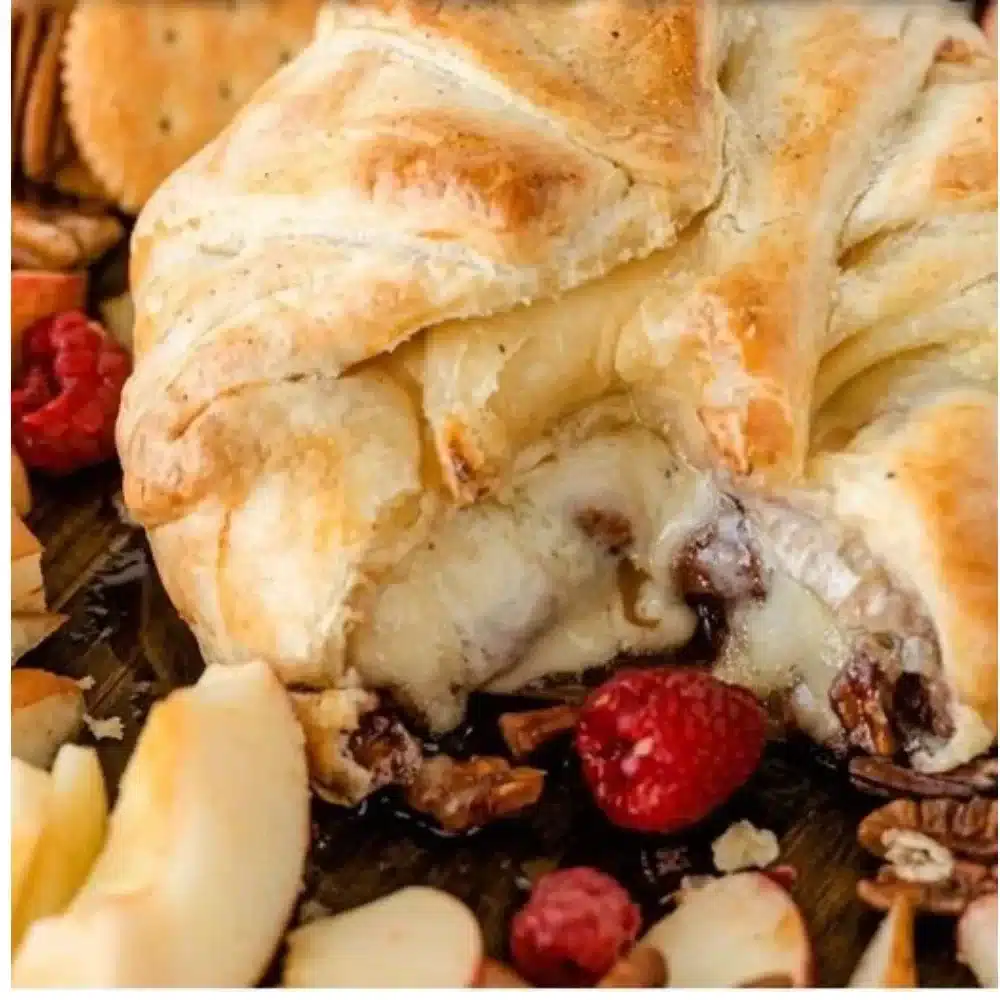 Brie and fruit preserve puff pastry bites plated as a delightful appetizer