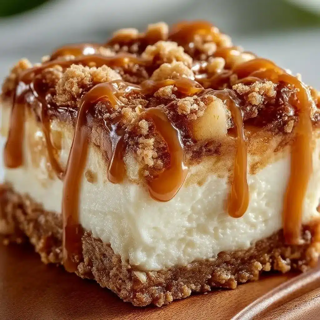 Delicious caramel apple cheesecake bars topped with caramel drizzle and apple slices.