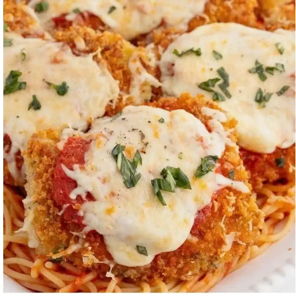 Juicy Chicken Parmesan Thighs topped with marinara sauce and melted cheese