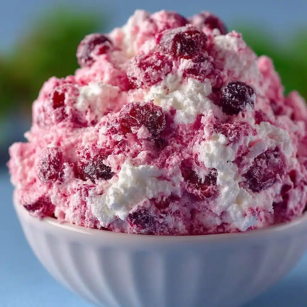 Delicious bowl of Cranberry Fluff dessert with whipped cream and cranberries