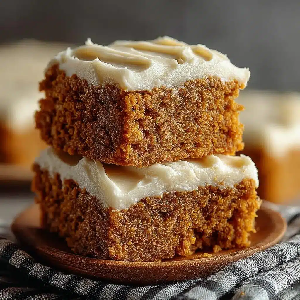 Delicious pumpkin bars with brown sugar frosting on a rustic wooden table