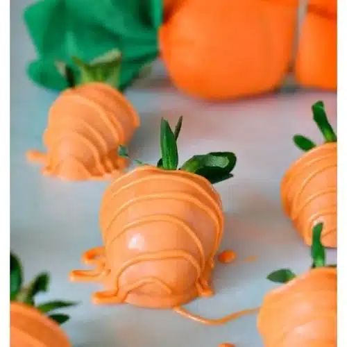 Delicious carrot chocolate covered strawberries arranged on a platter