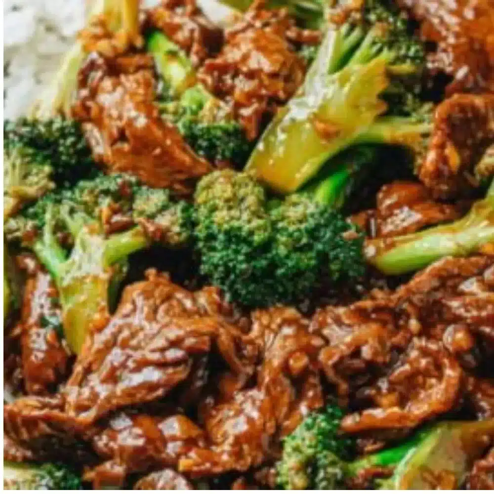 Plate of Chinese beef and broccoli stir-fry with tender beef and green vegetables.