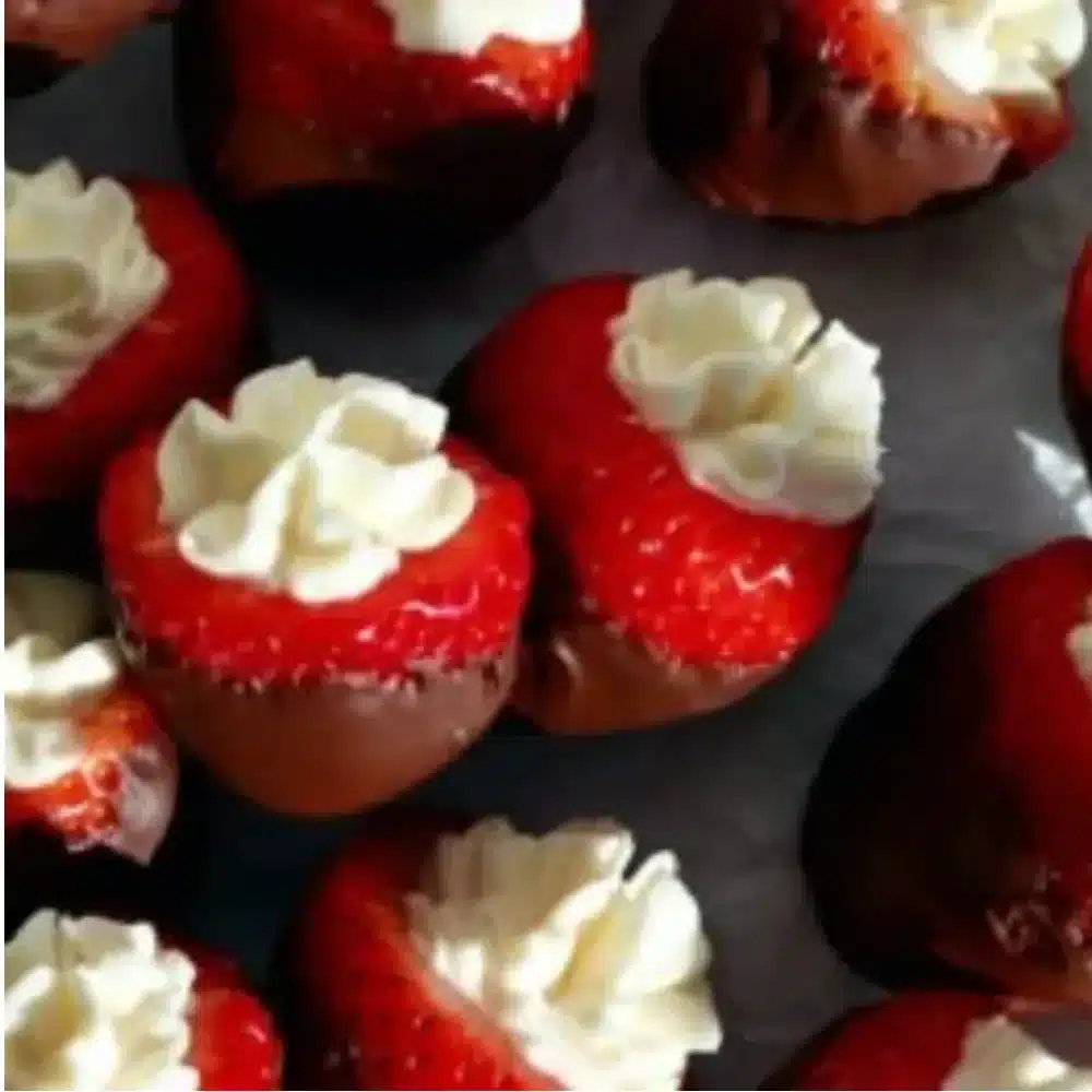 Delicious chocolate covered cheesecake strawberries on a white plate