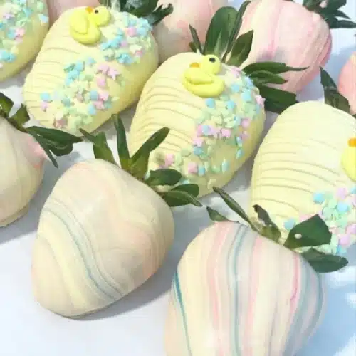 A plate of chocolate covered strawberries, an elegant dessert for any celebration.