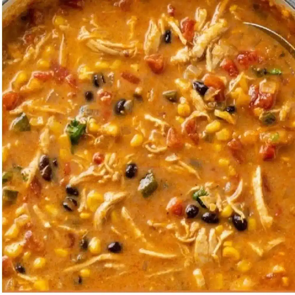 Bowl of creamy Chicken Tortilla Soup topped with tortilla strips and fresh cilantro