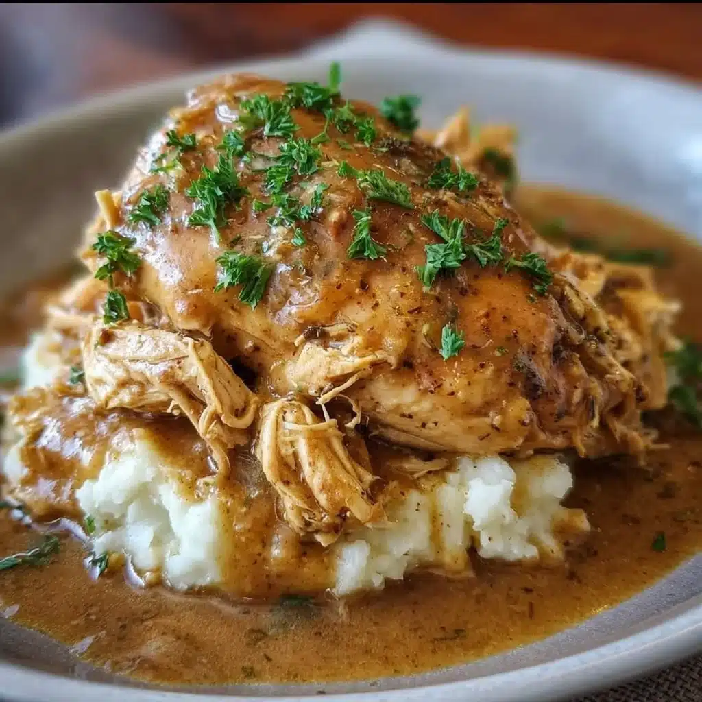 Delicious Crockpot Chicken and Gravy served on a plate with sides
