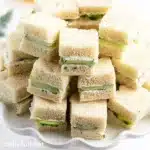 Delicious cucumber sandwiches on a plate, perfect for tea parties.