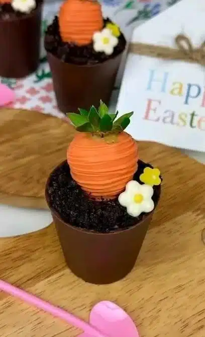 Easter Dirt Cups dessert with chocolate, gummy worms, and crushed cookies.