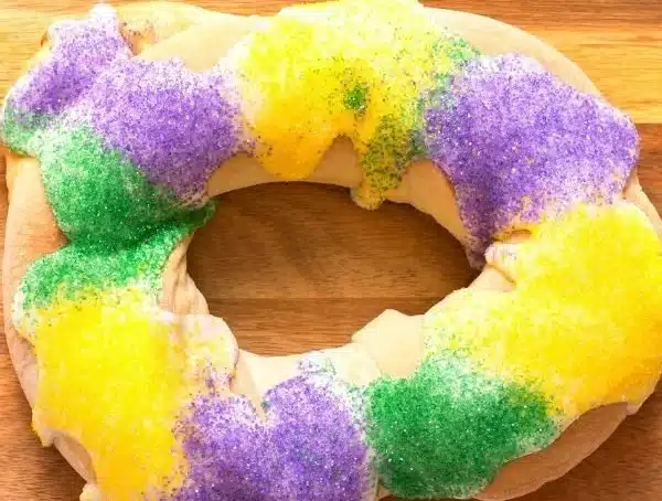 Easy King Cake recipe with colorful icing and traditional decorations.