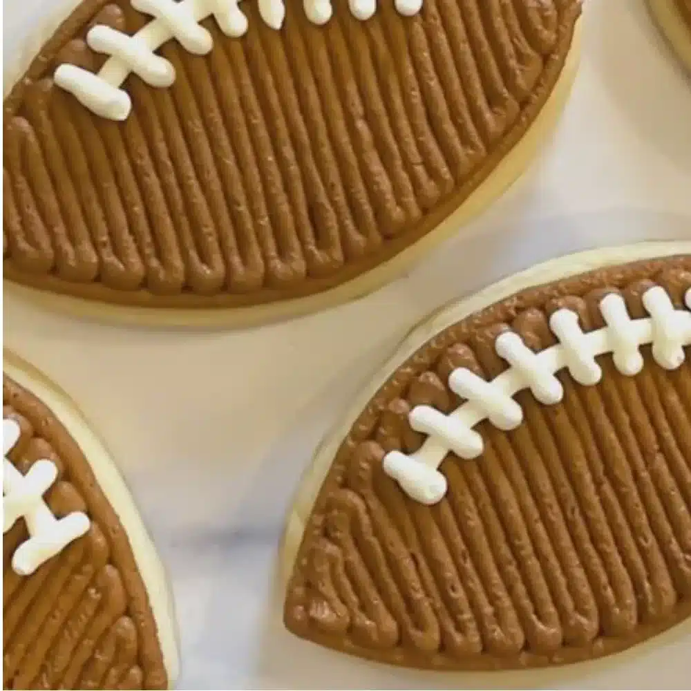 Decorated Football Sugar Cookies with Buttercream Frosting on a white platter