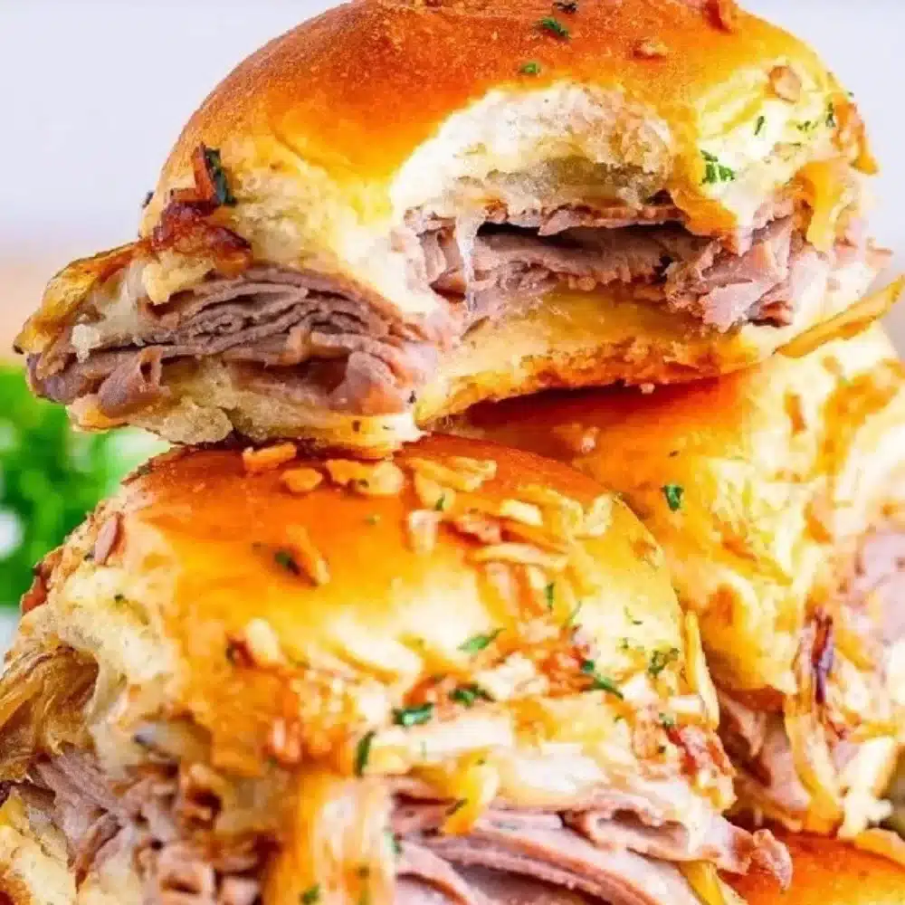 Delicious French Dip Sliders served with au jus for dipping
