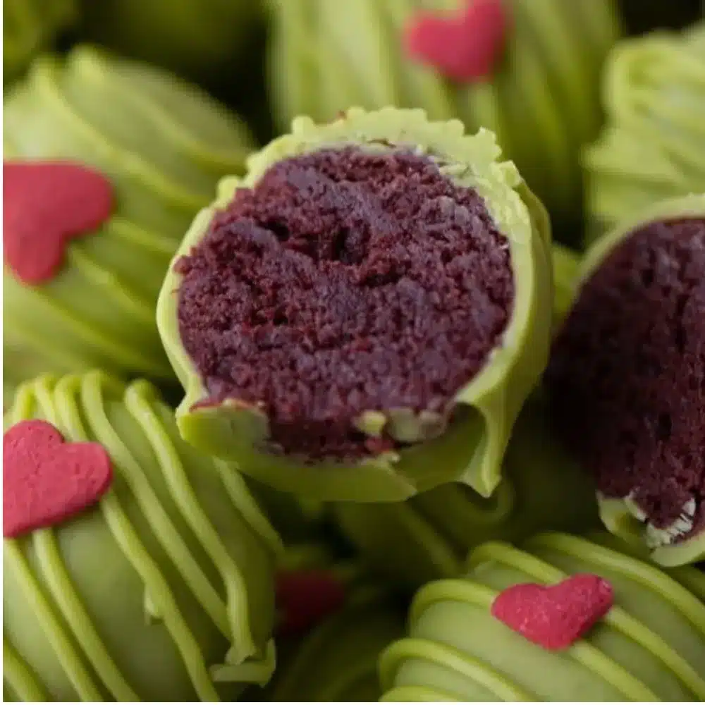 Festively decorated Grinch Oreo Truffles ready for holiday enjoyment