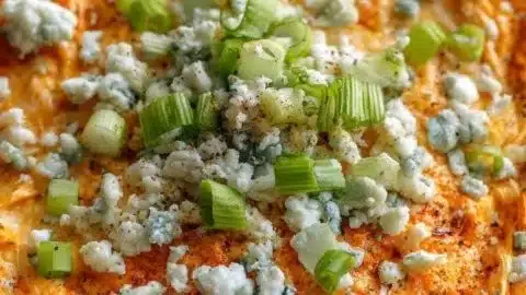 Healthy high-protein buffalo chicken dip served in a bowl with celery sticks