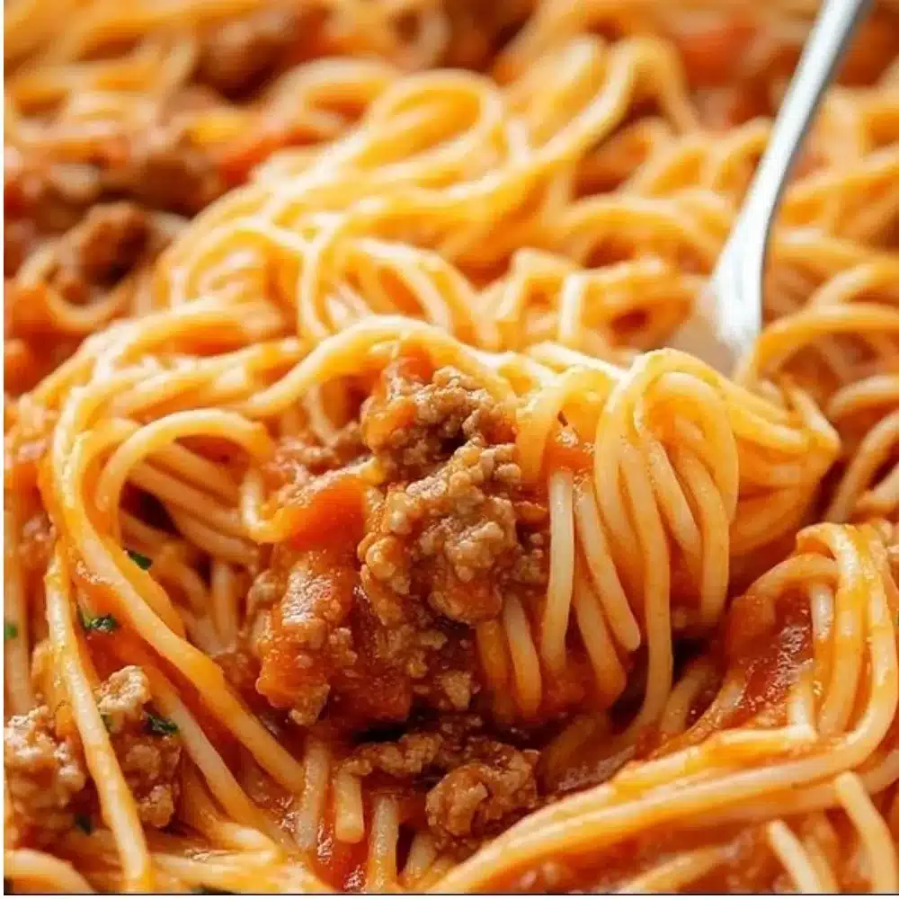 Hearty spaghetti dish served for a crowd, showcasing delicious ingredients.