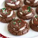 Delicious hot cocoa cookies topped with marshmallows on a festive plate.
