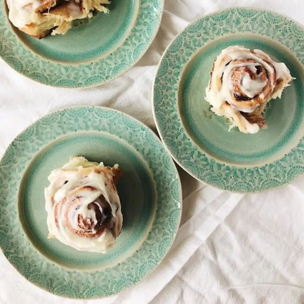 Delicious homemade cinnamon rolls topped with icing ready for breakfast