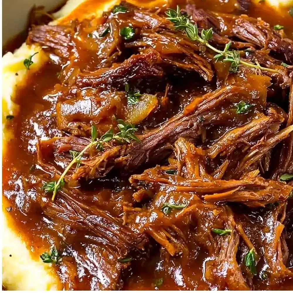 Juicy French Onion Pot Roast served with caramelized onions and herbs