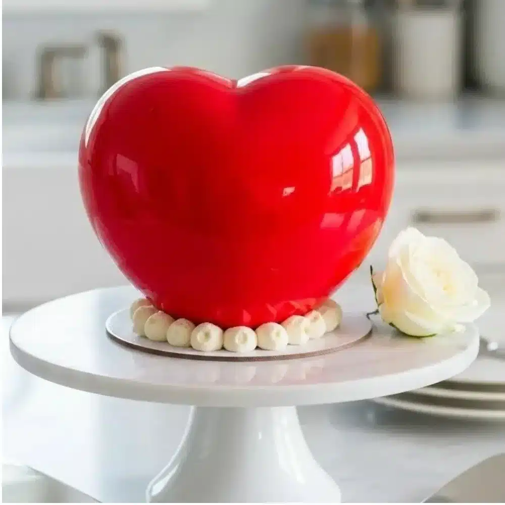 A beautiful Mirror Glaze Heart Cake showcasing a shiny, reflective finish.