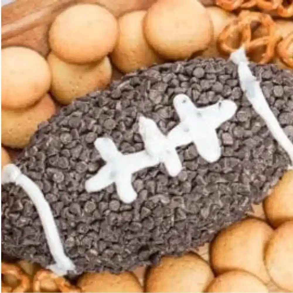 Delicious Oreo cream cheese football dip served in a festive bowl