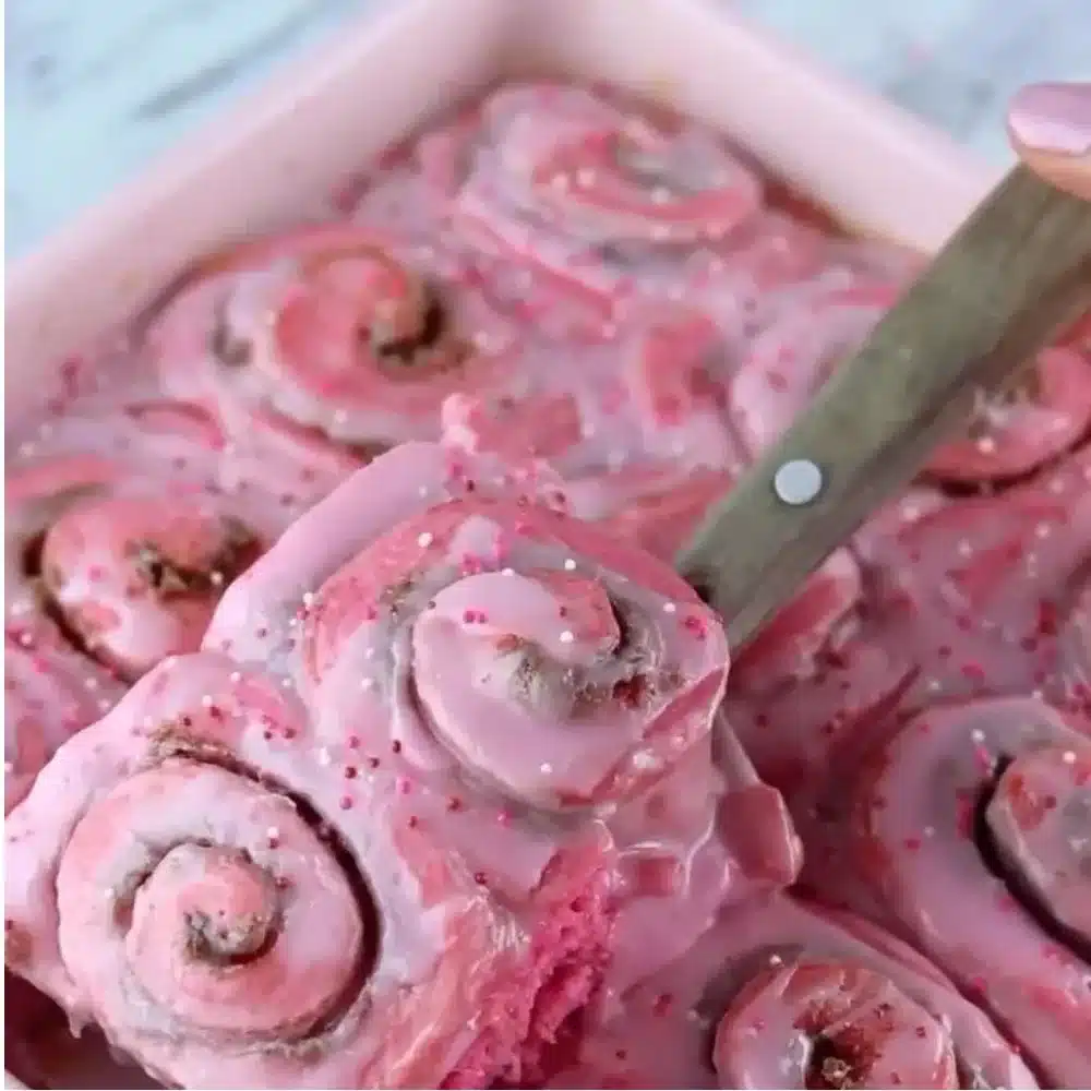 Pink Velvet Cinnamon Rolls topped with cream cheese frosting