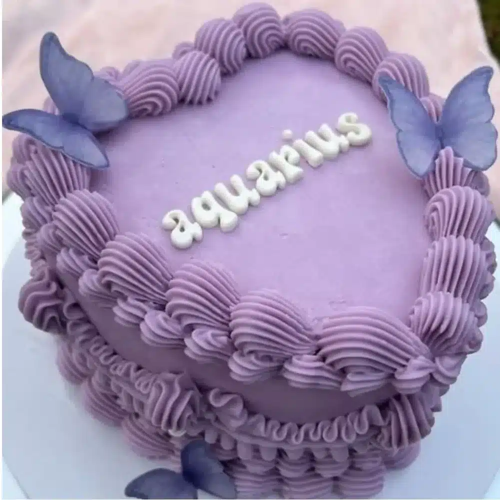 Purple buttercream birthday cake with butterflies for Aquarius season celebration
