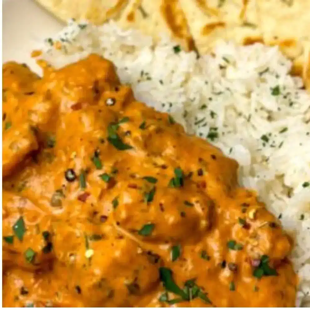 Delicious homemade butter chicken served with rice and naan