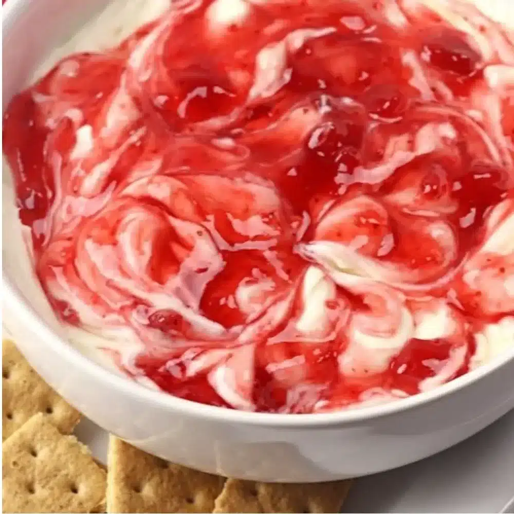Delicious strawberry cheesecake dip served in a bowl with fresh strawberries