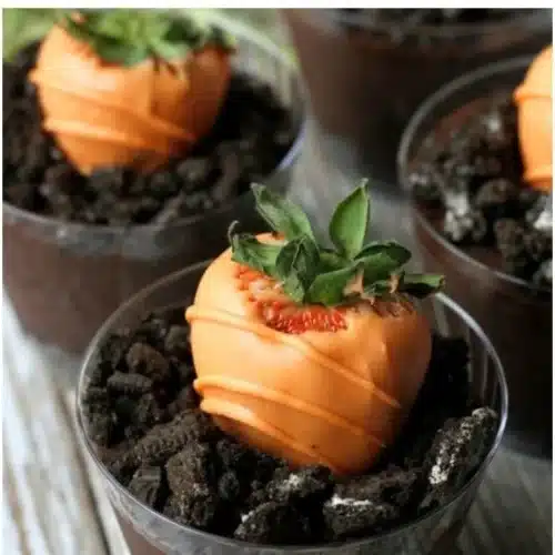 Chocolate covered strawberries decorated with orange candy melts for Easter