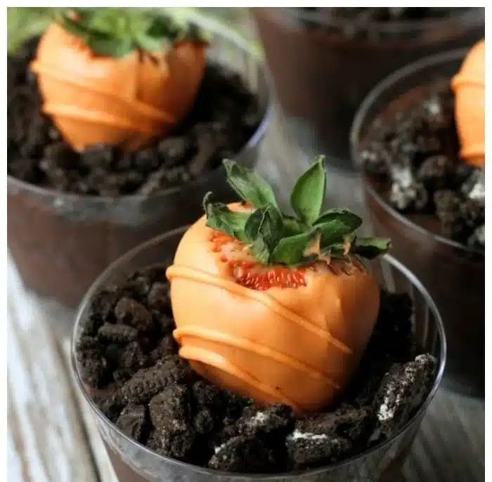 Chocolate covered strawberries decorated with orange candy melts for Easter