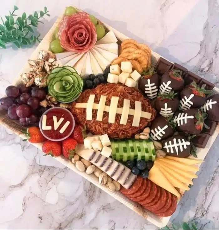 A beautiful Super Bowl charcuterie board featuring meats, cheeses, and snacks.