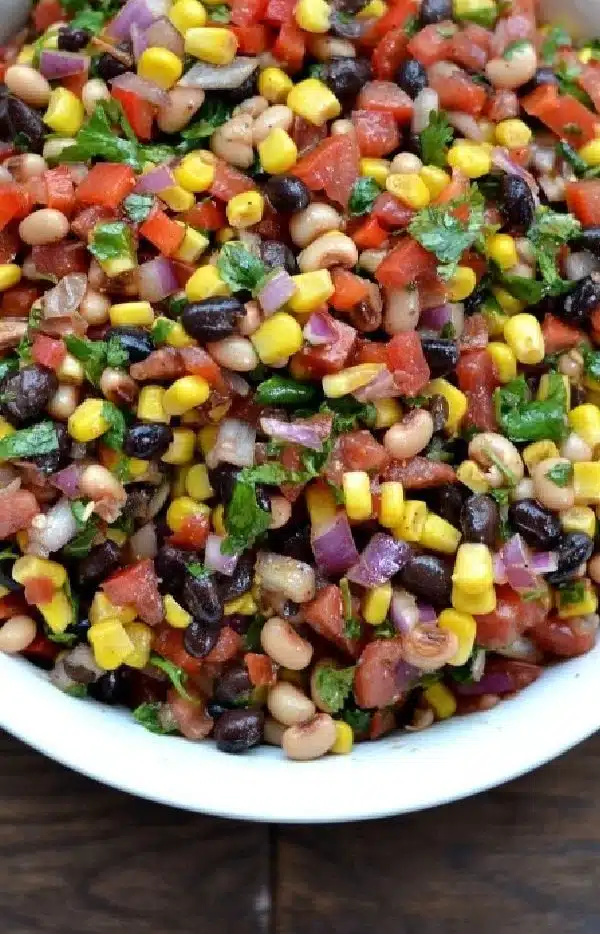A bowl of colorful Cowboy Caviar salad with beans and vegetables