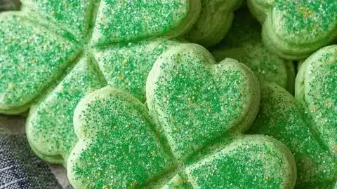 Baked shamrock cookies decorated with green icing for St. Patrick's Day.