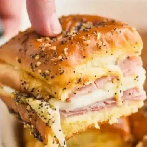 Ham and cheese sliders served on a plate, ideal for parties and gatherings