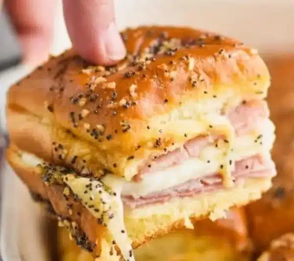 Ham and cheese sliders served on a plate, ideal for parties and gatherings