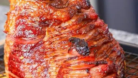 Succulent honey glazed ham ready to serve at a festive dinner.
