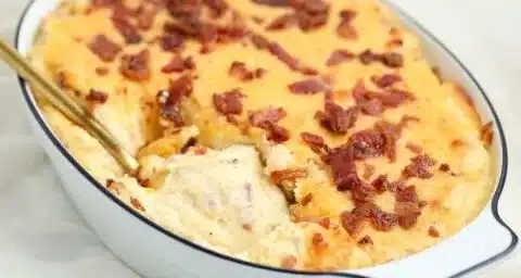 Creamy and cheesy mashed potato casserole topped with herbs and breadcrumbs.