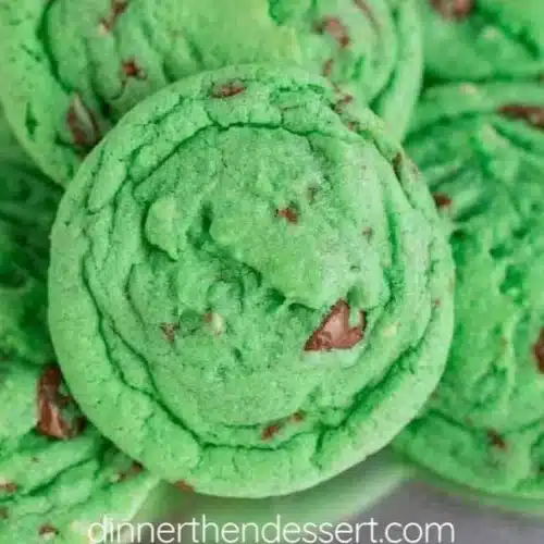 Freshly baked mint chocolate chip cookies on a cooling rack