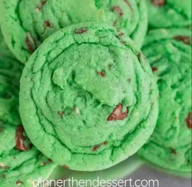 Freshly baked mint chocolate chip cookies on a cooling rack