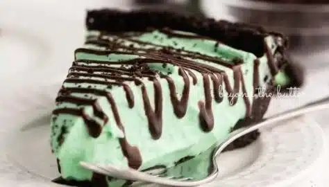 No Bake Mint Chocolate Pie topped with whipped cream and chocolate shavings