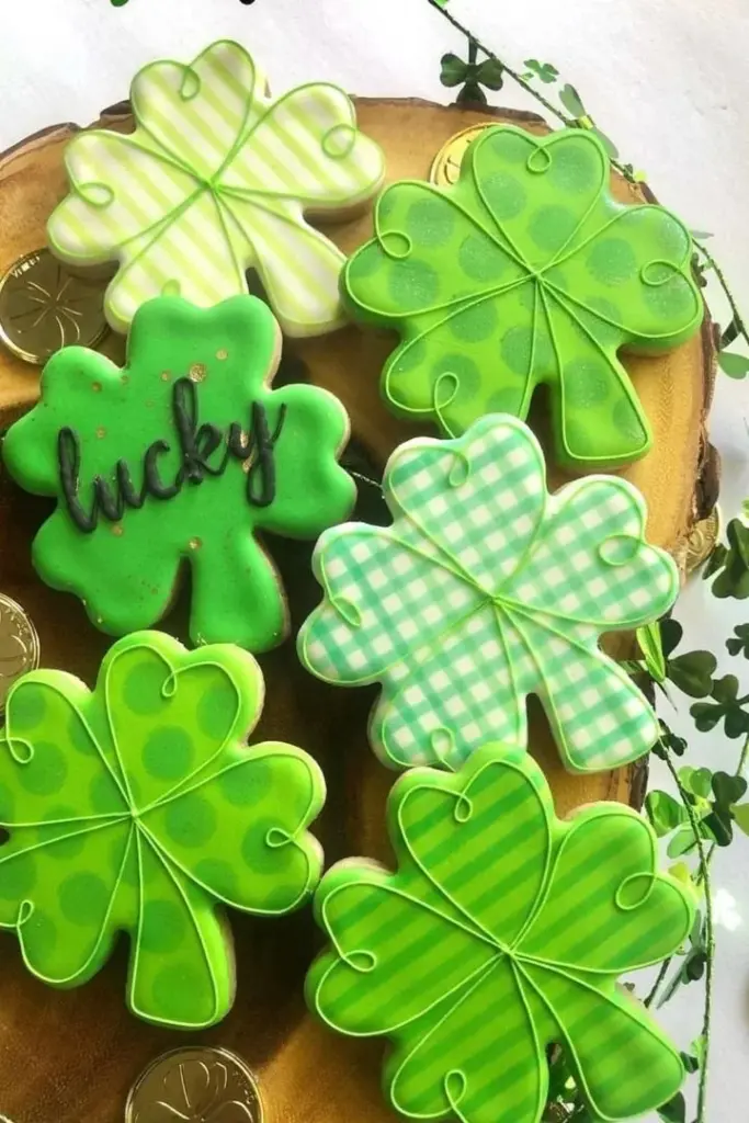 Decorative St. Patrick's Day cookies with green icing and shamrock designs.