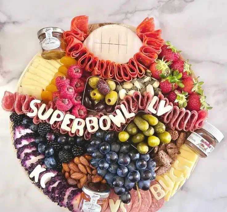 Delicious Super Bowl charcuterie board featuring meats, cheeses, and snacks.