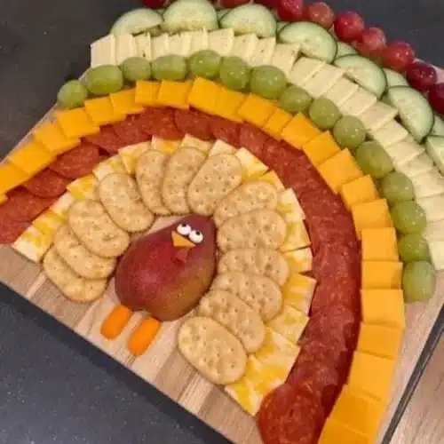 Beautiful Thanksgiving charcuterie turkey featuring gourmet cheeses and seasonal treats.