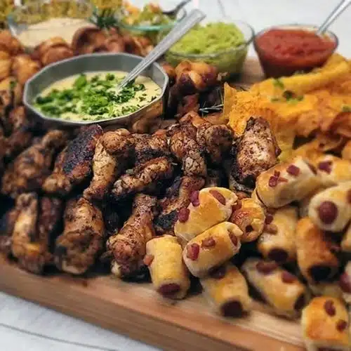 Delicious spread of the ultimate Super Bowl charcuterie board with various snacks