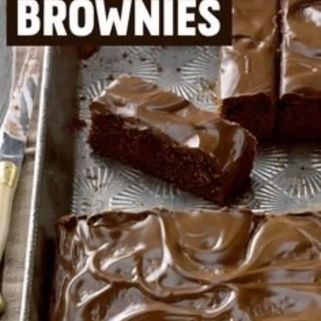 Zucchini brownies with chocolate frosting on a white plate